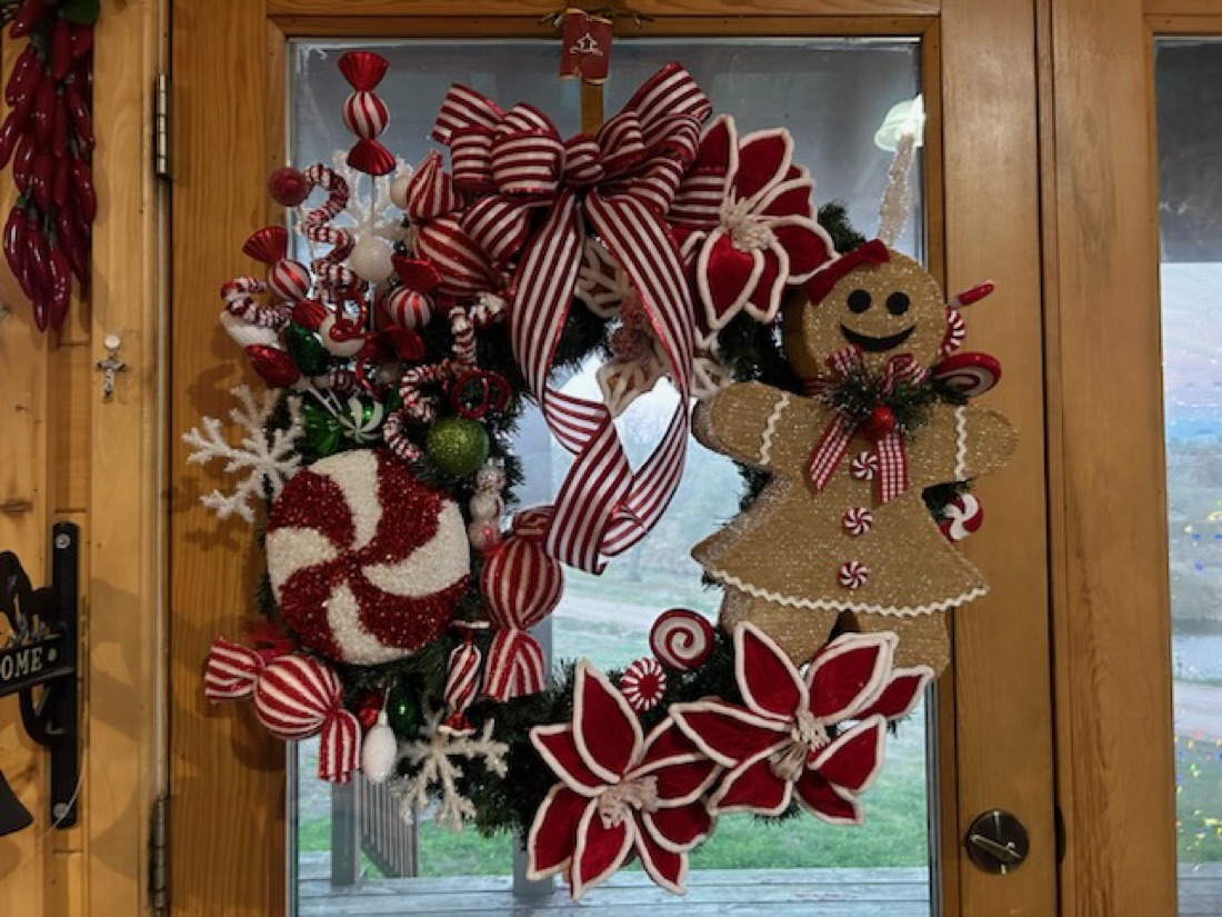 Holiday door wreath with candy themed decor