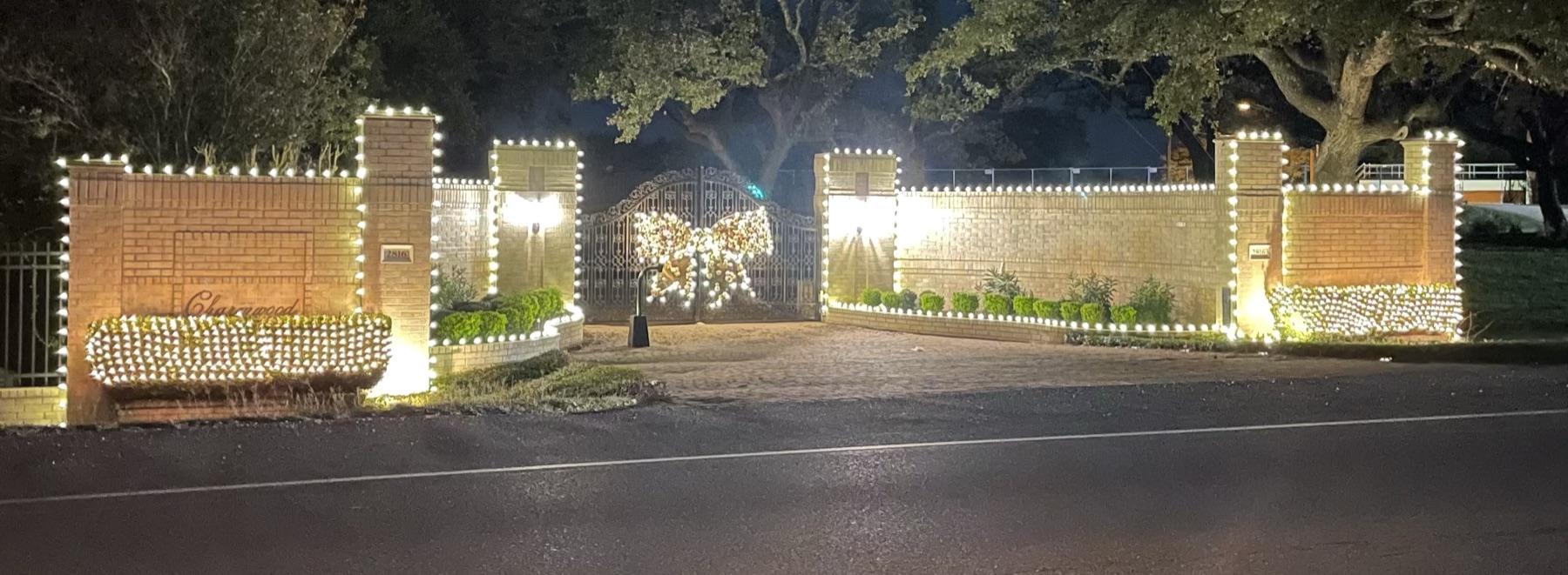 Gated entry with warm white Christmas lights