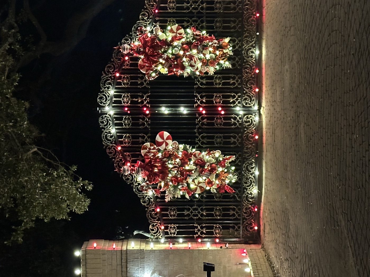 Red and white gate decor with Christmas lights