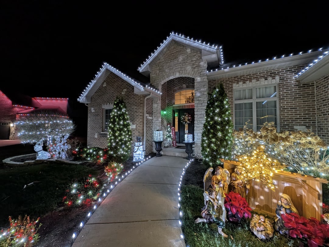 Bee Cave style home with premium Christmas roofline lights